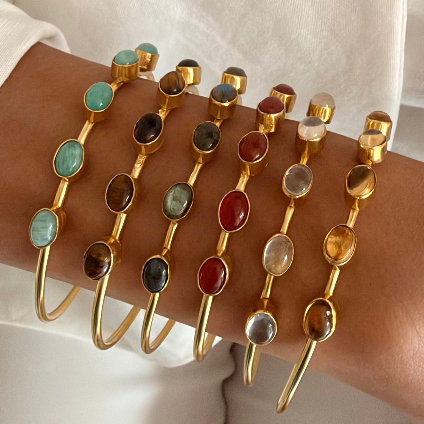 Casaata brass cuff bangle with  oval natural stones and a high-gold finish