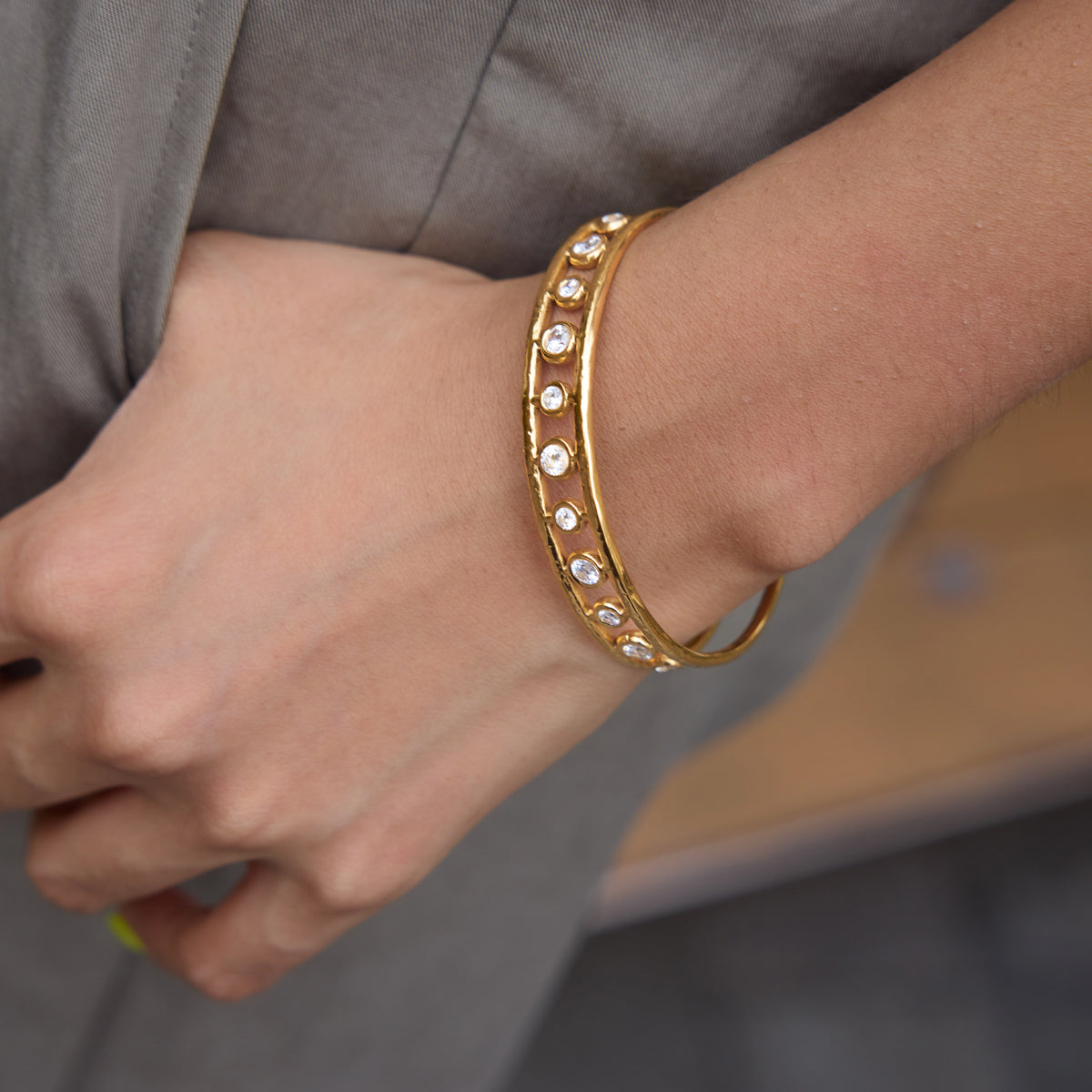 A girl wearing circle stone bangle