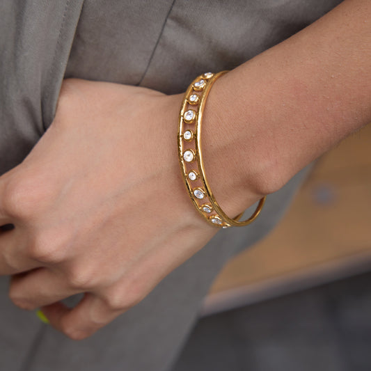 A girl wearing circle stone bangle