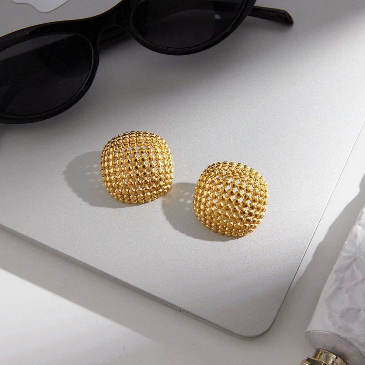 Domed gold-tone earrings with intricate openwork