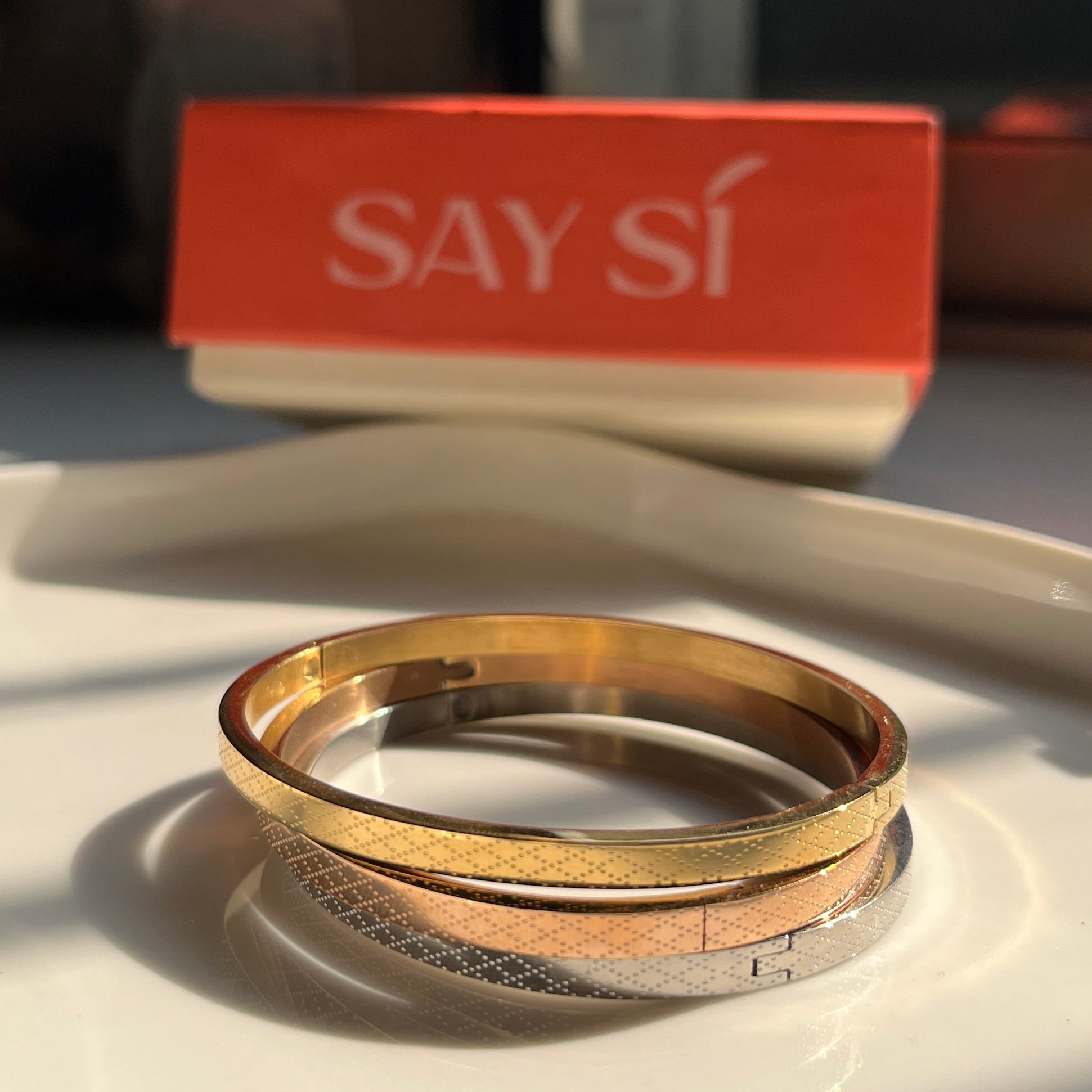 Three bangles - rose gold, gold and silver with a Say Si Box