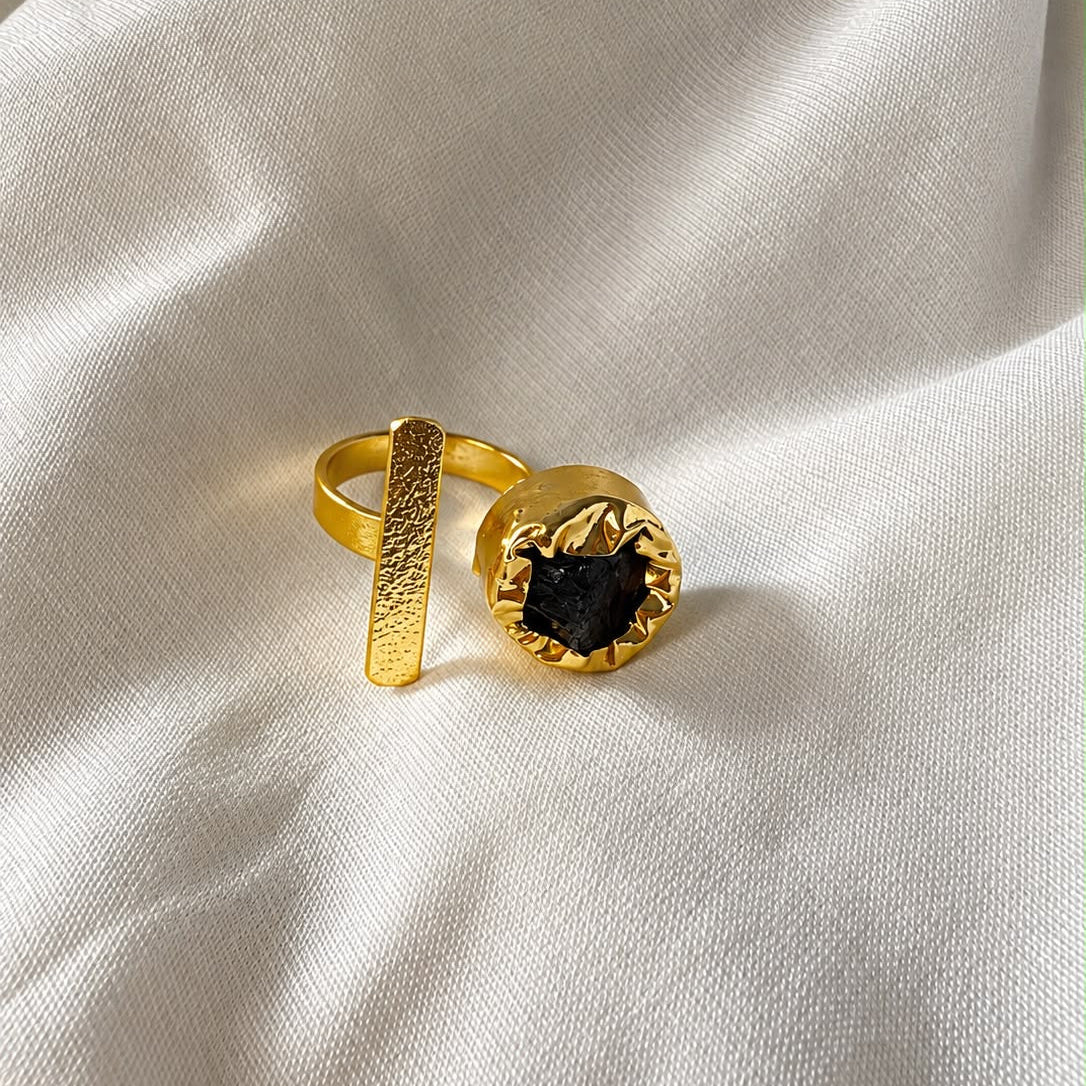Deep black stone framed by a sculptural gold-finish setting on the Ada Ring