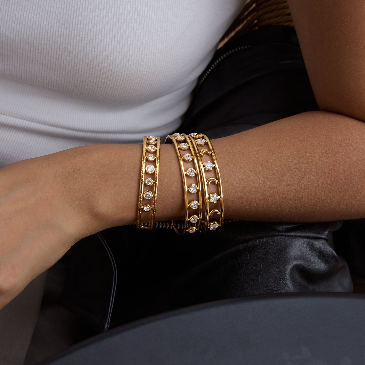 A girl wearing 3 golden bracelet