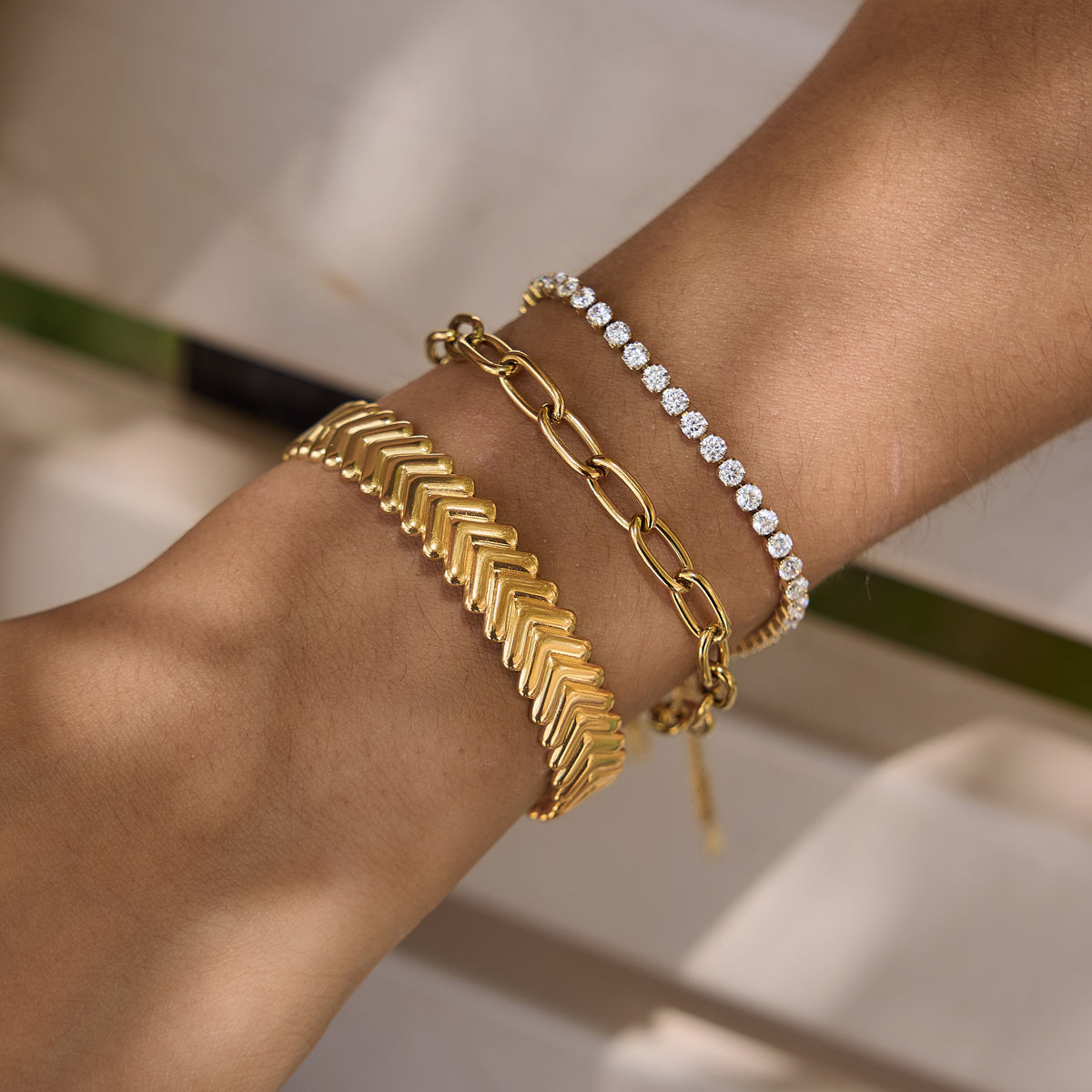 a girl wearing a stack of bracelets