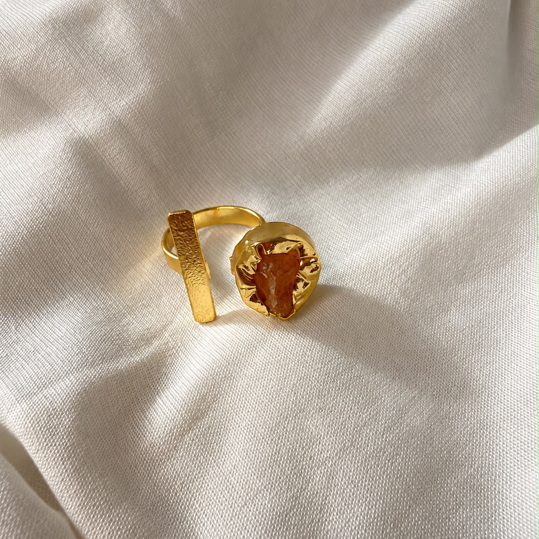 Ada Ring with an amber-orange natural stone and a textured gold-finish bar