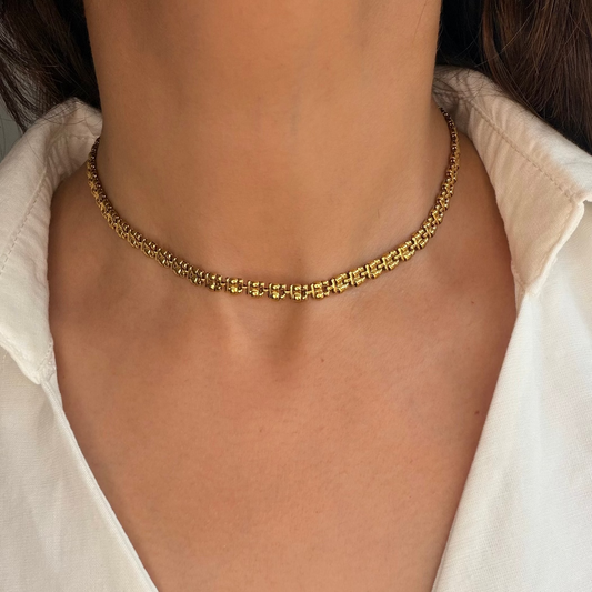 Zari Necklace worn along the collarbone with an open white shirt