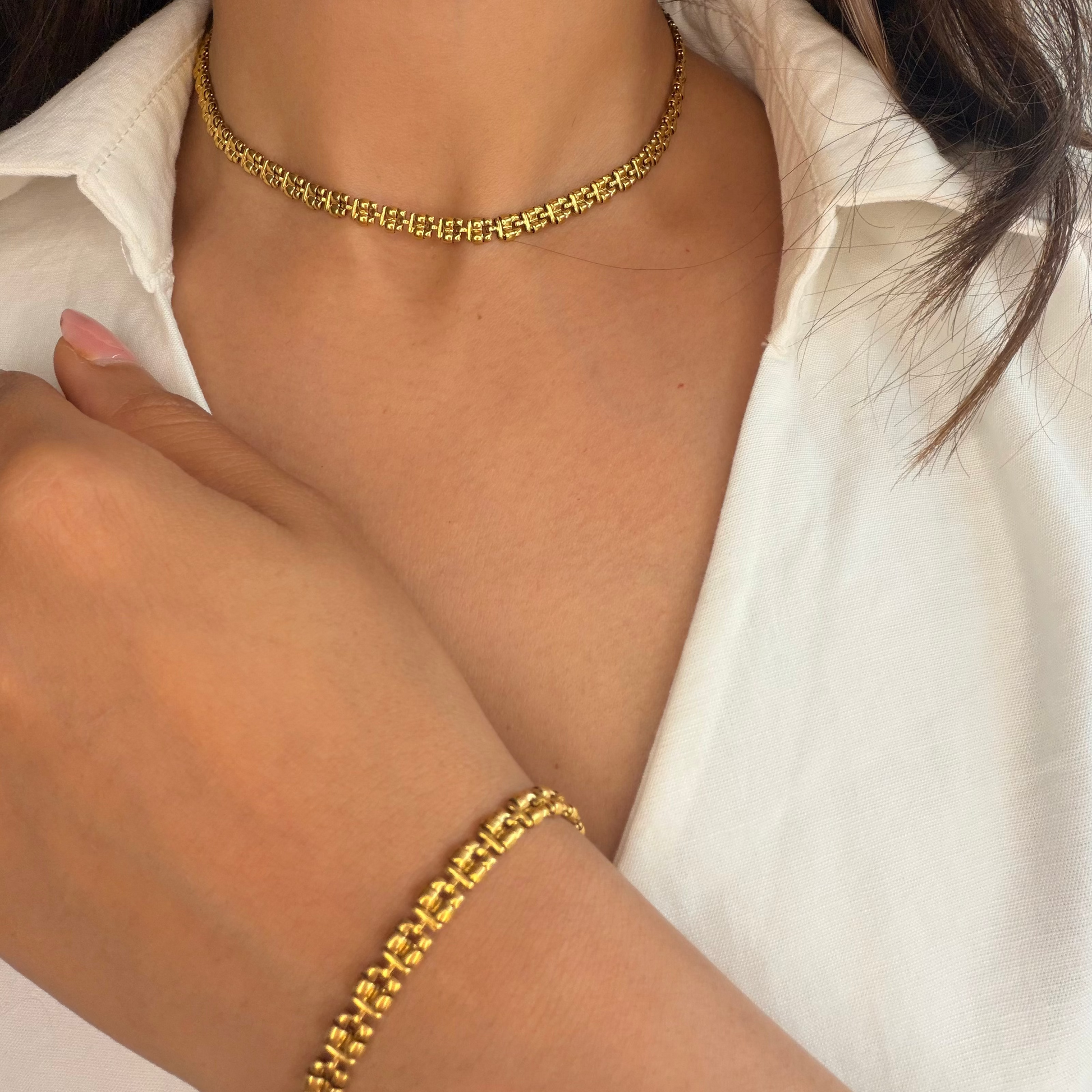 Zari necklaced paired with matching Zari bracelet worn by a model wearing a white shirt